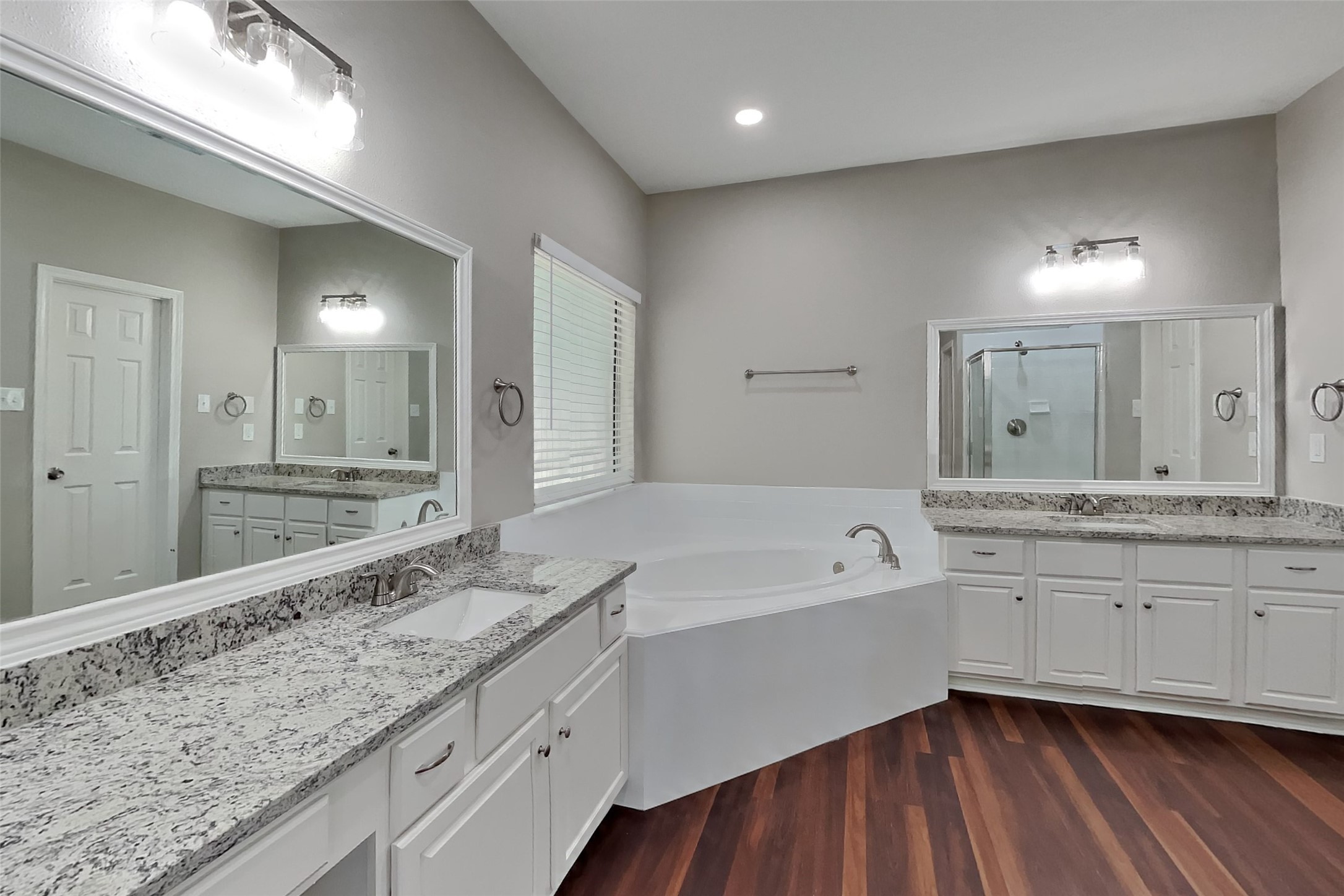 8615 Mile Run Road Humble, TX 77346 - Photo 9 of 19 a bathroom with a granite countertop double vanity sink and mirror with bathtub