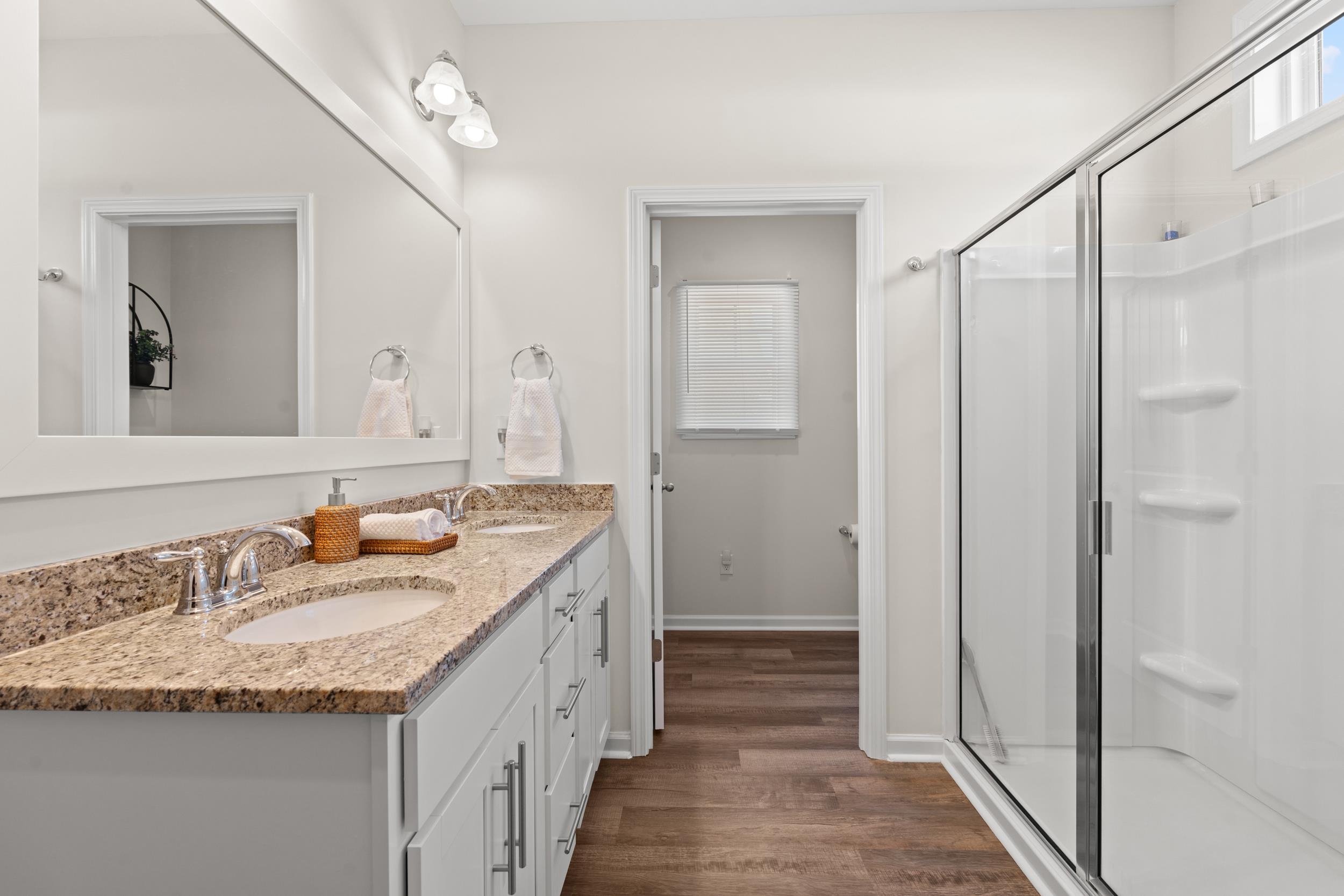 361 Palmetto Sand Loop Conway, SC 29527 - Photo 16 of 28 Bathroom featuring double vanity, dark wood-style flooring, and a stall shower