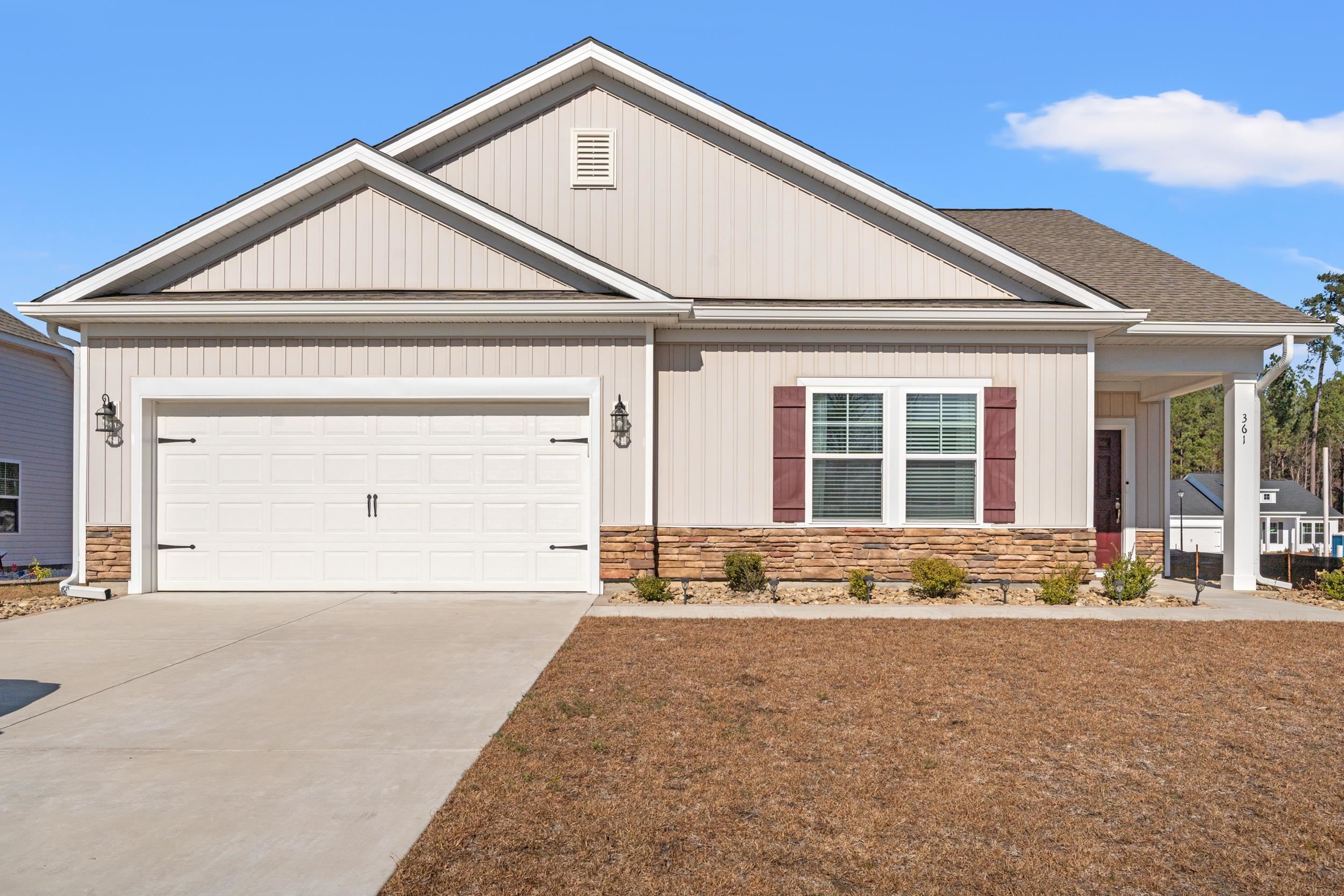 361 Palmetto Sand Loop Conway, SC 29527 - Photo 2 of 28 View of front of property with stone siding, driveway, a garage, and a shingled roof