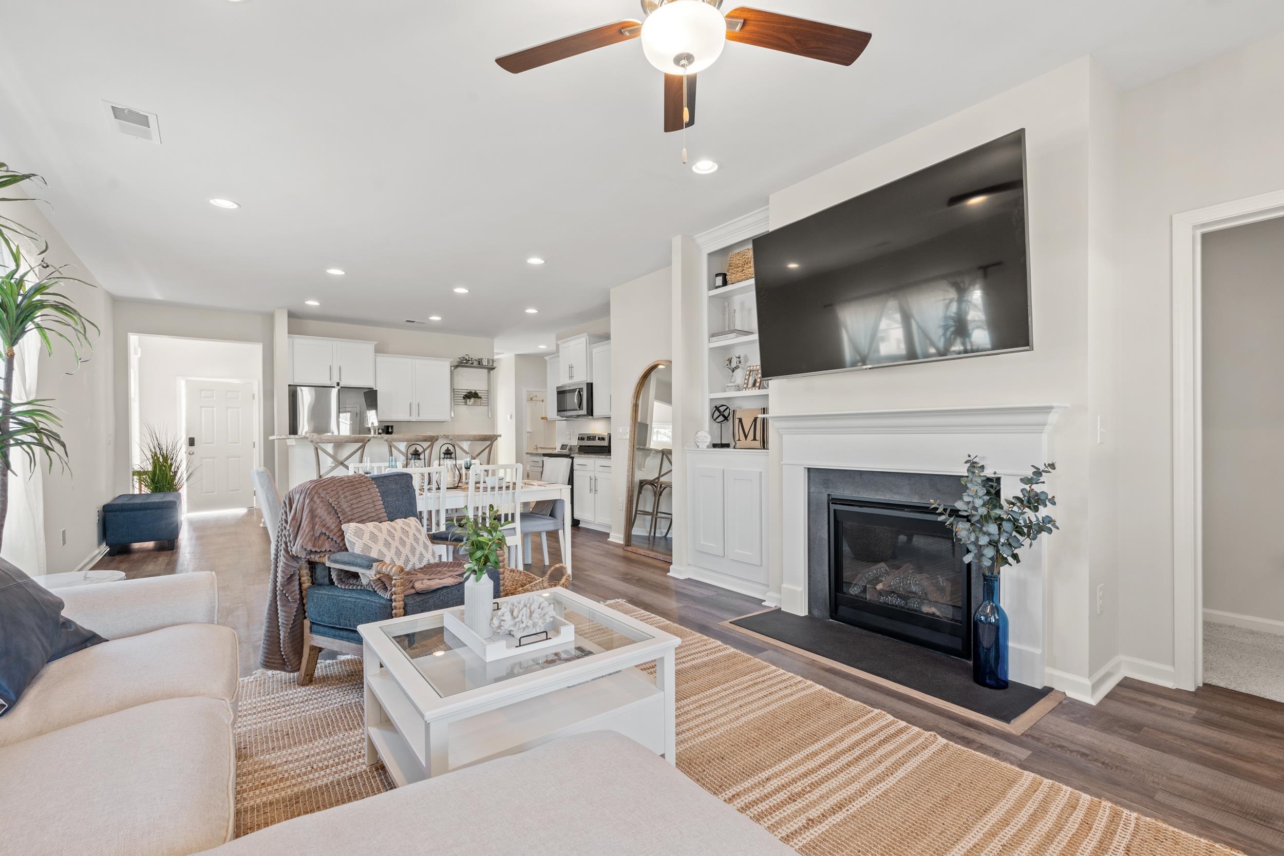 361 Palmetto Sand Loop Conway, SC 29527 - Photo 9 of 28 Living room with a glass covered fireplace, built in shelves, recessed lighting, ceiling fan, and wood finished floors