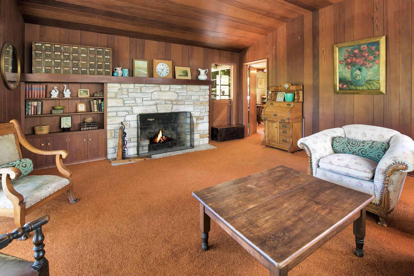157 Happy Valley Road Santa Cruz, CA 95065 - Photo 11 of 45 a living room with furniture a rug and a fireplace
