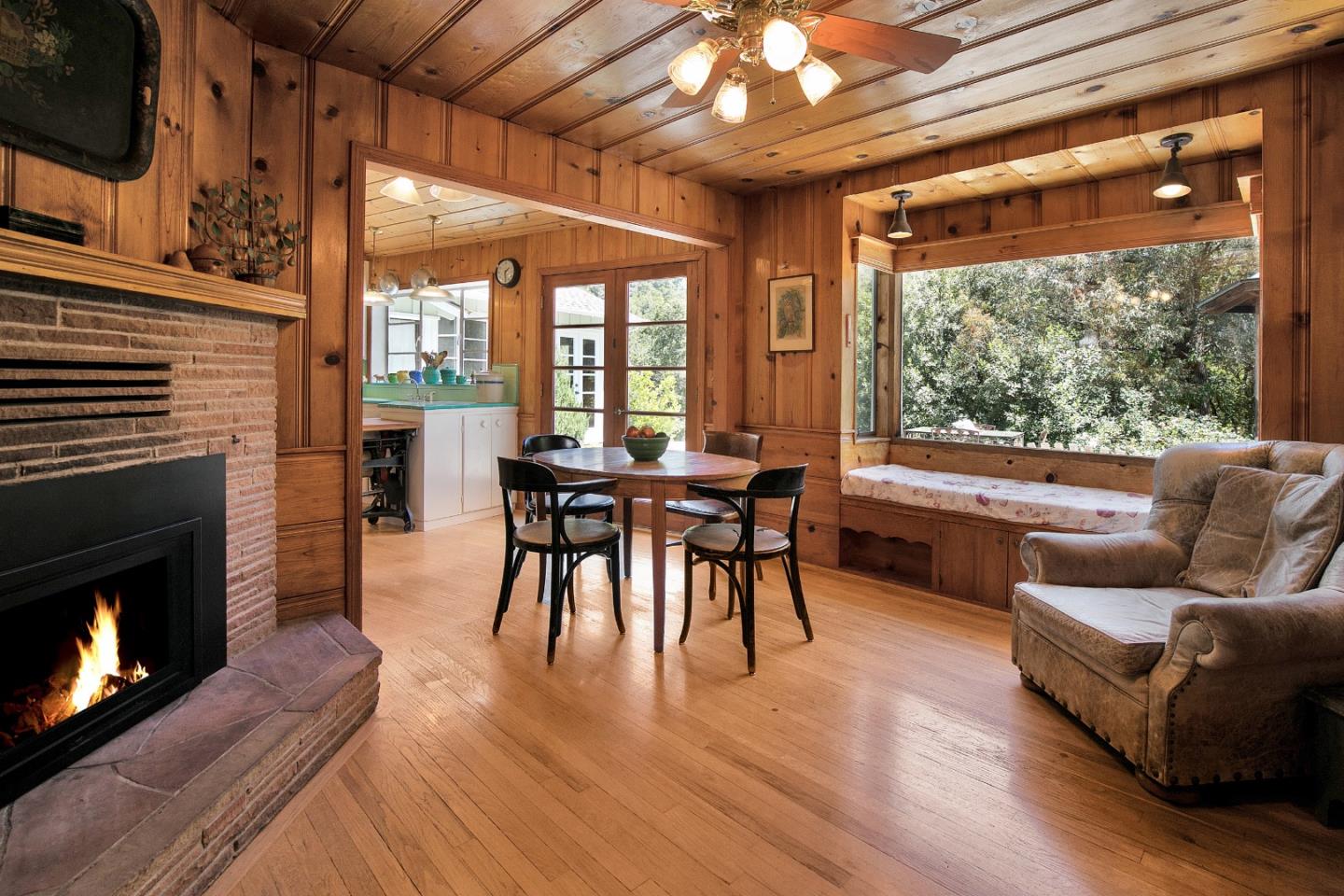 157 Happy Valley Road Santa Cruz, CA 95065 - Photo 12 of 45 a dining room with furniture a fireplace and wooden floor