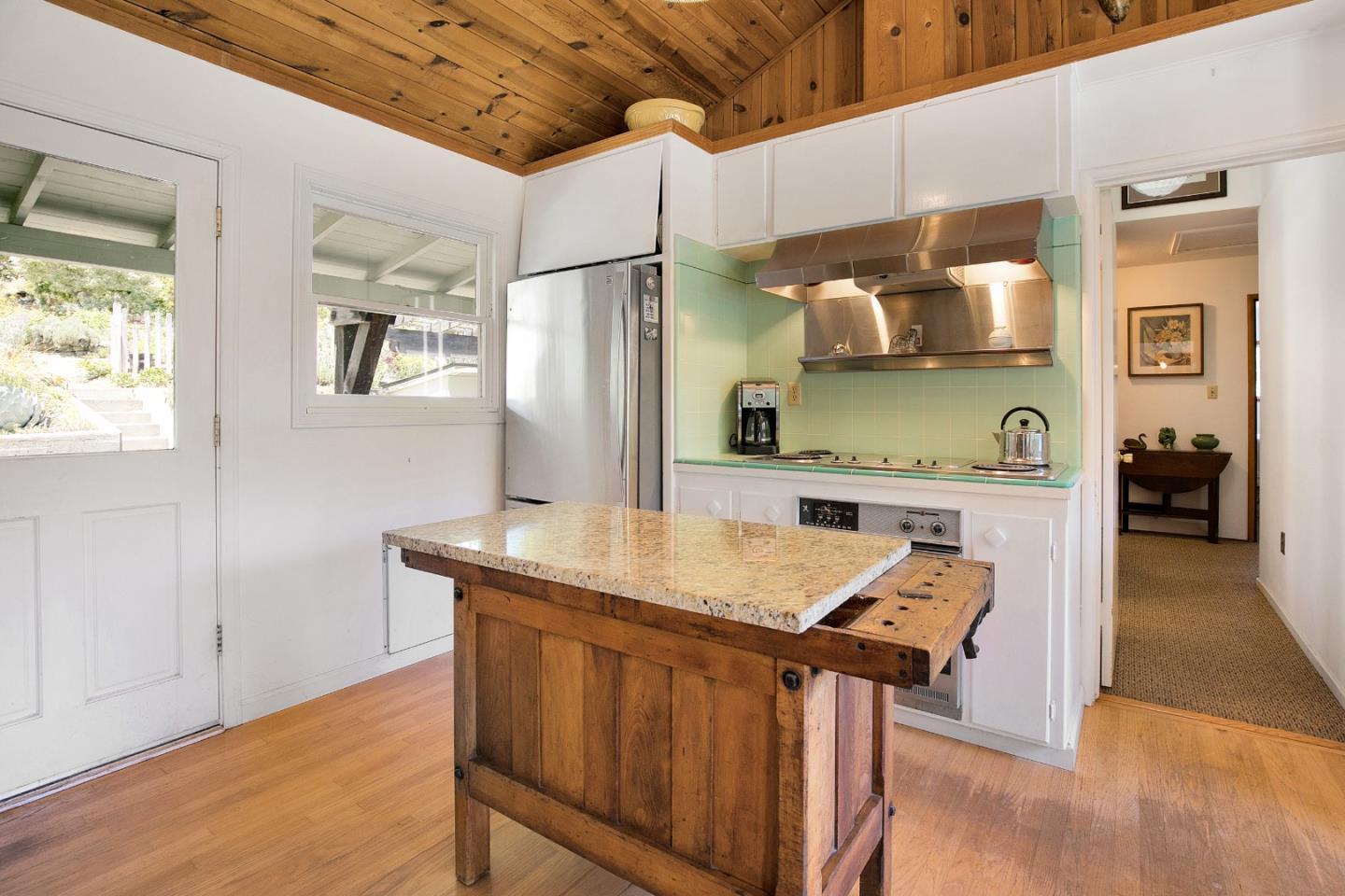 157 Happy Valley Road Santa Cruz, CA 95065 - Photo 19 of 45 a kitchen with a wooden floor and a refrigerator