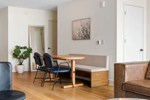 a view of a dining room with furniture window and wooden floor