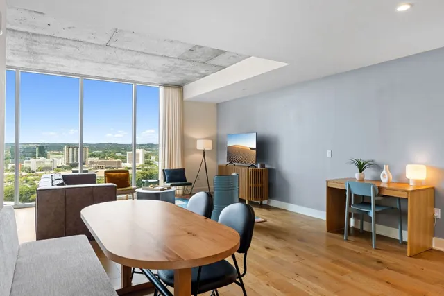 a living room with furniture and a large window