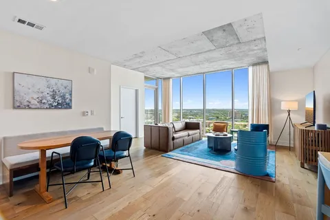 a large kitchen with lots of counter space a sink and chairs