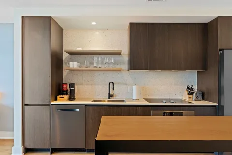 a view of kitchen with cabinets and wooden floor
