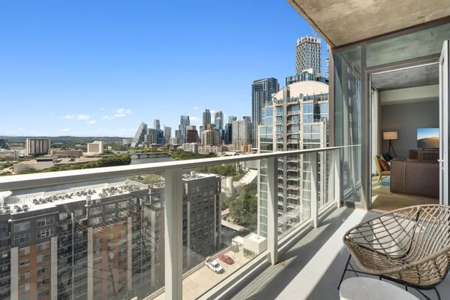 a view of a balcony with chair and glass door