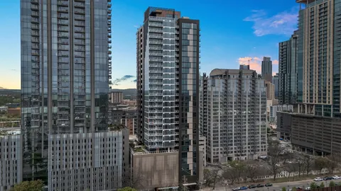 a view of a swimming pool with a patio and garden
