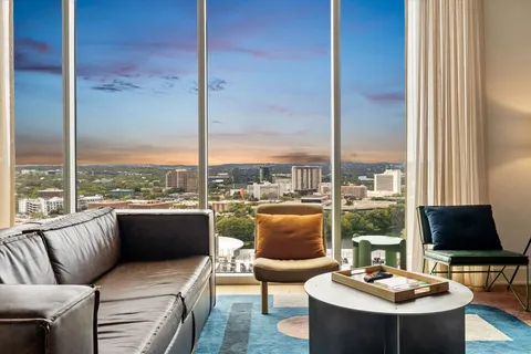 a living room with furniture and a lamp