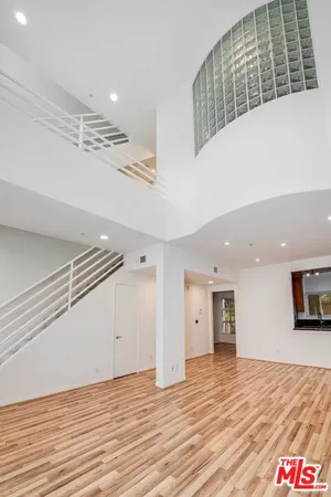 a view of empty room with wooden floor and fireplace