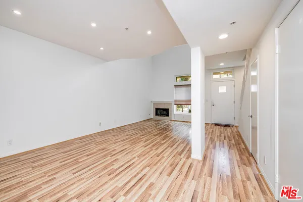 a view of a room with wooden floor and a window