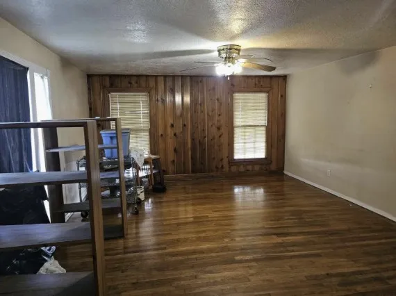 a view of a livingroom kitchen and dining room with wooden floor