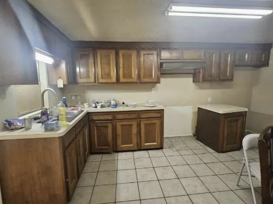 a kitchen with a sink stove and cabinets