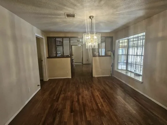 a view of livingroom with hardwood floor and kitchen view