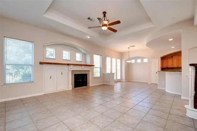 a view of an empty room with a fireplace and a window