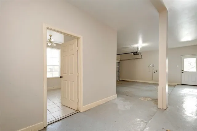 an empty room with windows and entrance