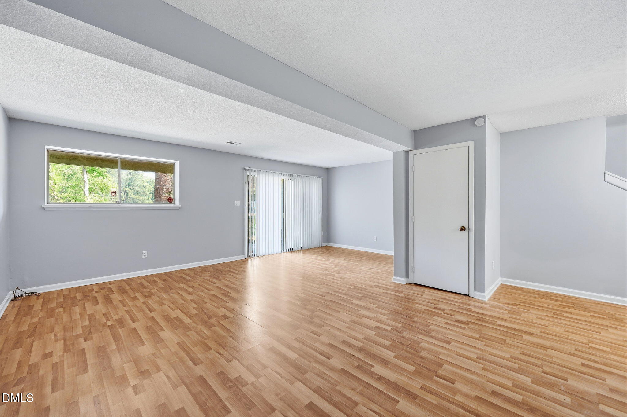 5043 Tall Pines Court Raleigh, NC 27609 - Photo 26 of 37 a view of an empty room with wooden floor and a window