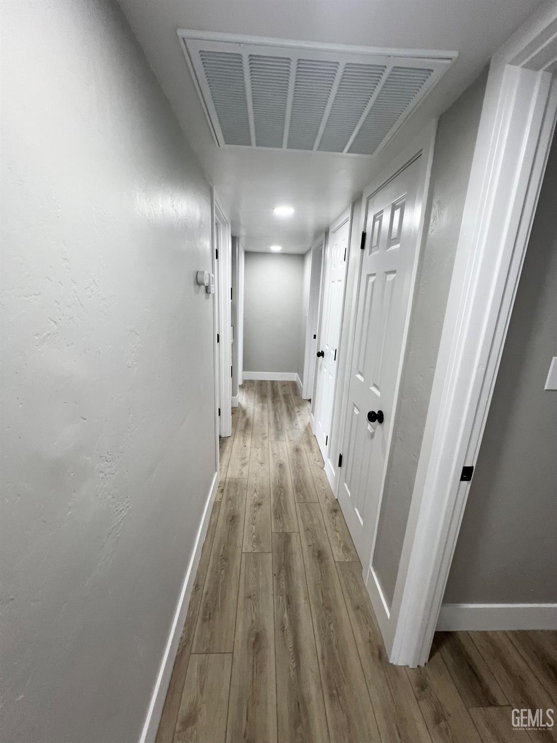 Undisclosed Address Bakersfield, CA 93307 - Photo 11 of 24 a view of a hallway with wooden floor