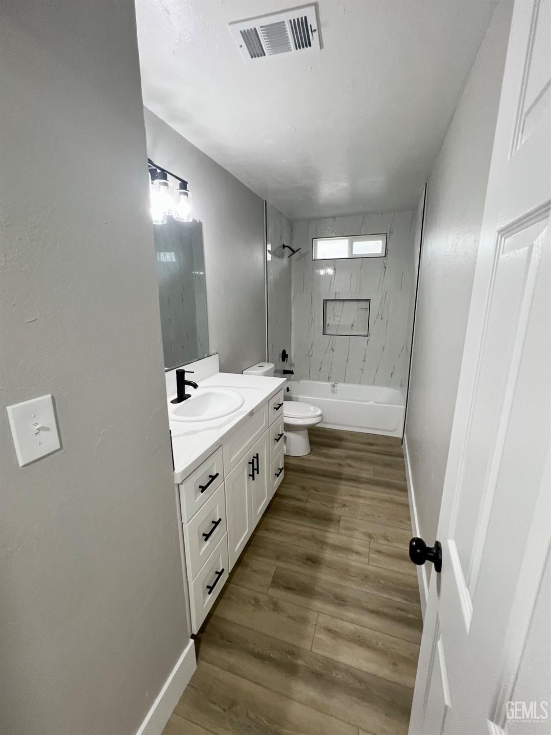 Undisclosed Address Bakersfield, CA 93307 - Photo 12 of 24 a bathroom with a double vanity sink and mirror