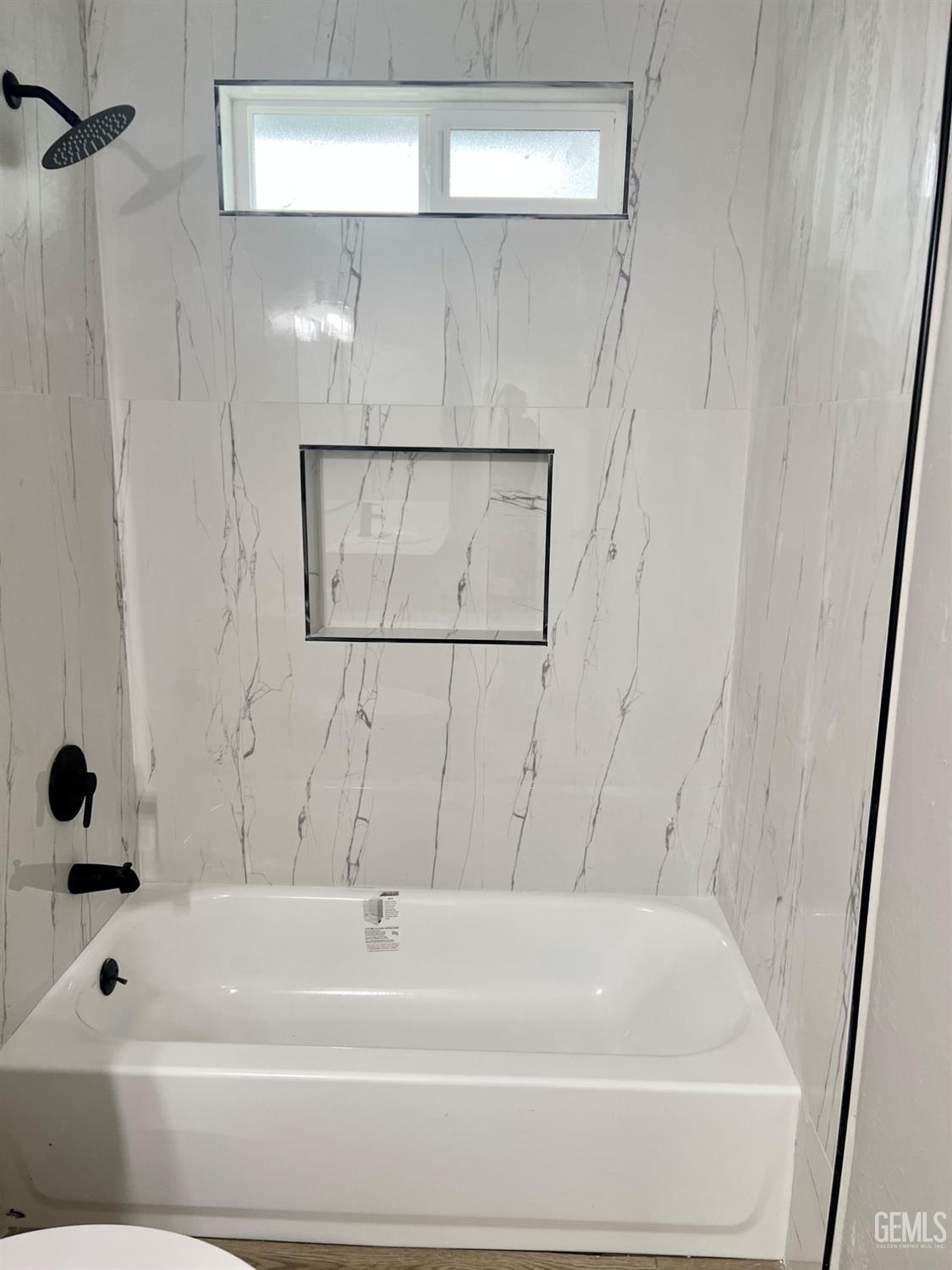 Undisclosed Address Bakersfield, CA 93307 - Photo 13 of 24 a bathroom with a bathtub