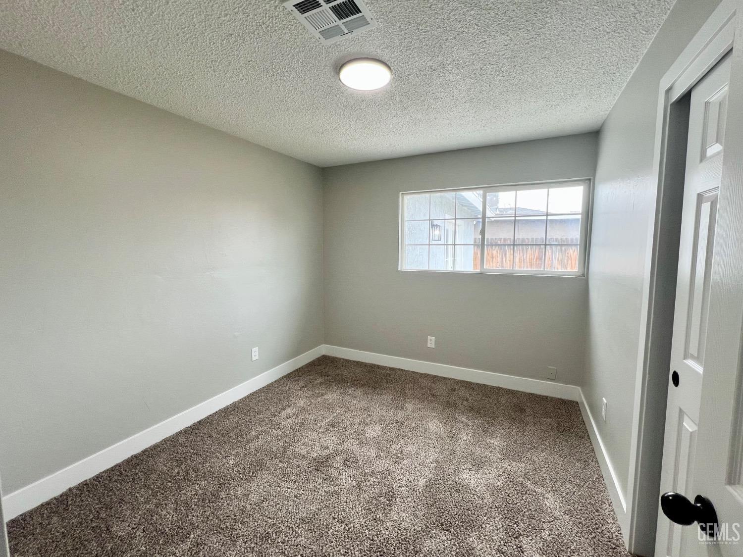Undisclosed Address Bakersfield, CA 93307 - Photo 15 of 24 an empty room with windows