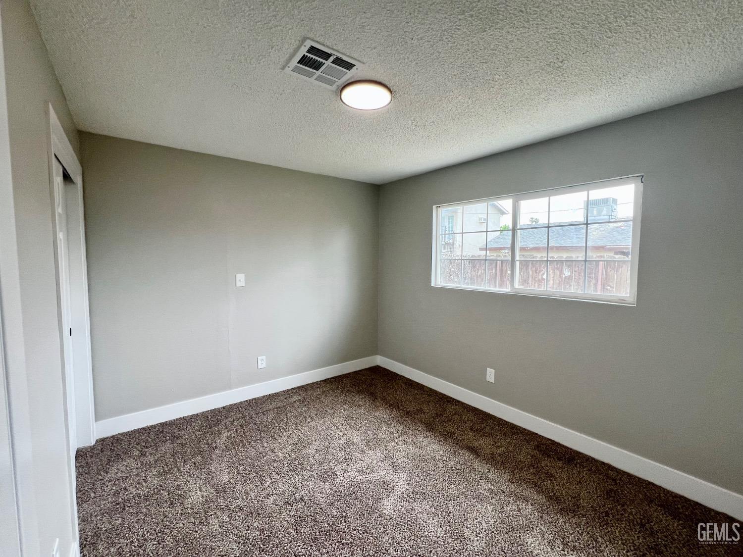 Undisclosed Address Bakersfield, CA 93307 - Photo 16 of 24 an empty room with windows