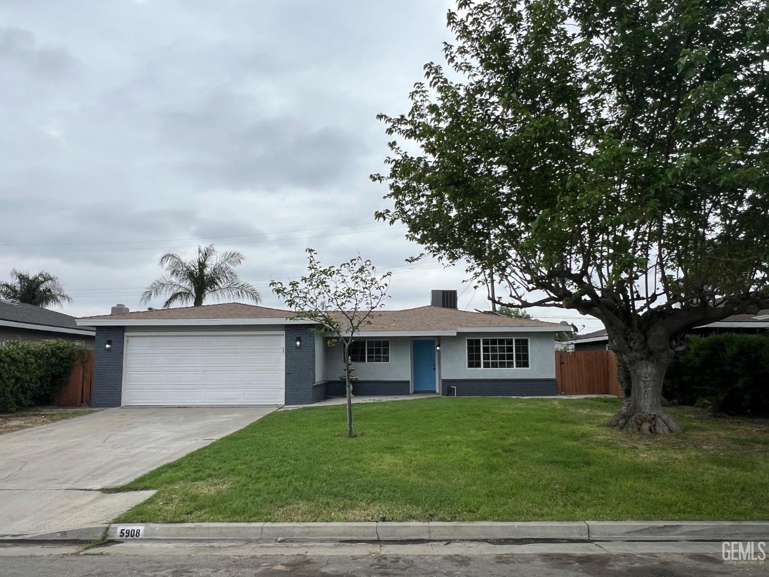 Undisclosed Address Bakersfield, CA 93307 - Photo 2 of 24 a front view of a house with a garden