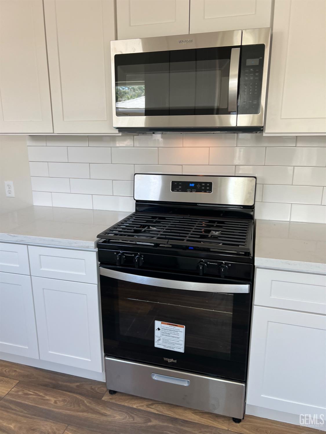 Undisclosed Address Bakersfield, CA 93307 - Photo 23 of 24 a stove top oven sitting inside of a kitchen