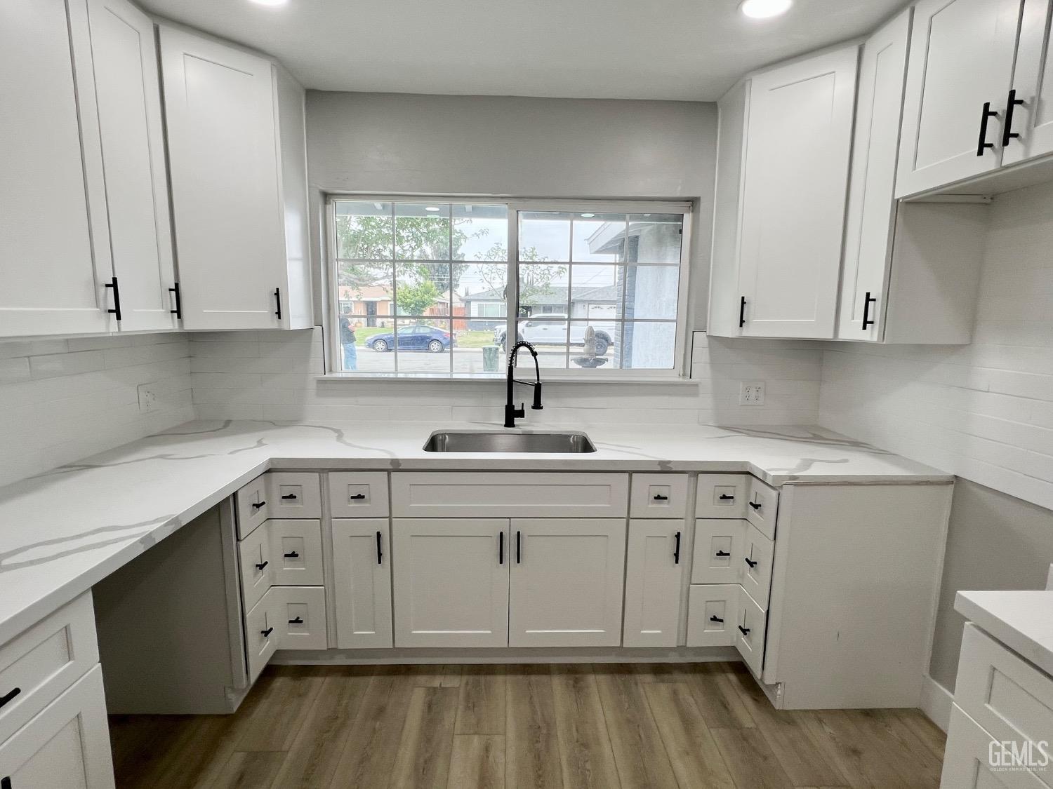 Undisclosed Address Bakersfield, CA 93307 - Photo 6 of 24 a kitchen with a sink cabinets and window