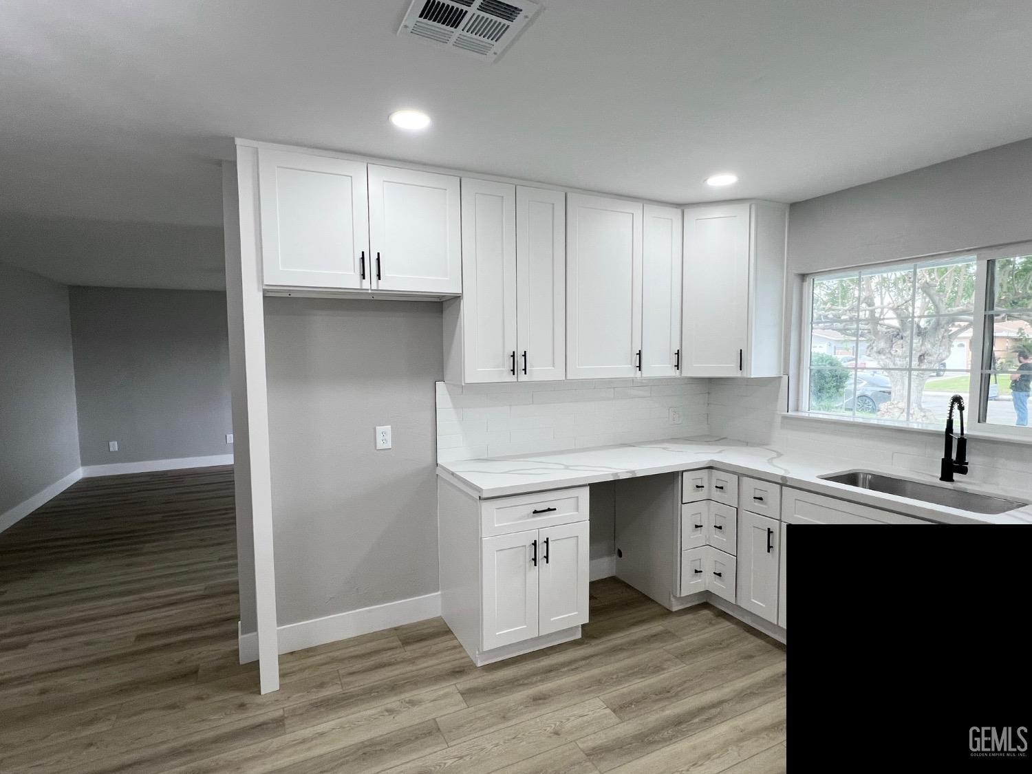 Undisclosed Address Bakersfield, CA 93307 - Photo 7 of 24 a kitchen with a sink cabinets and window