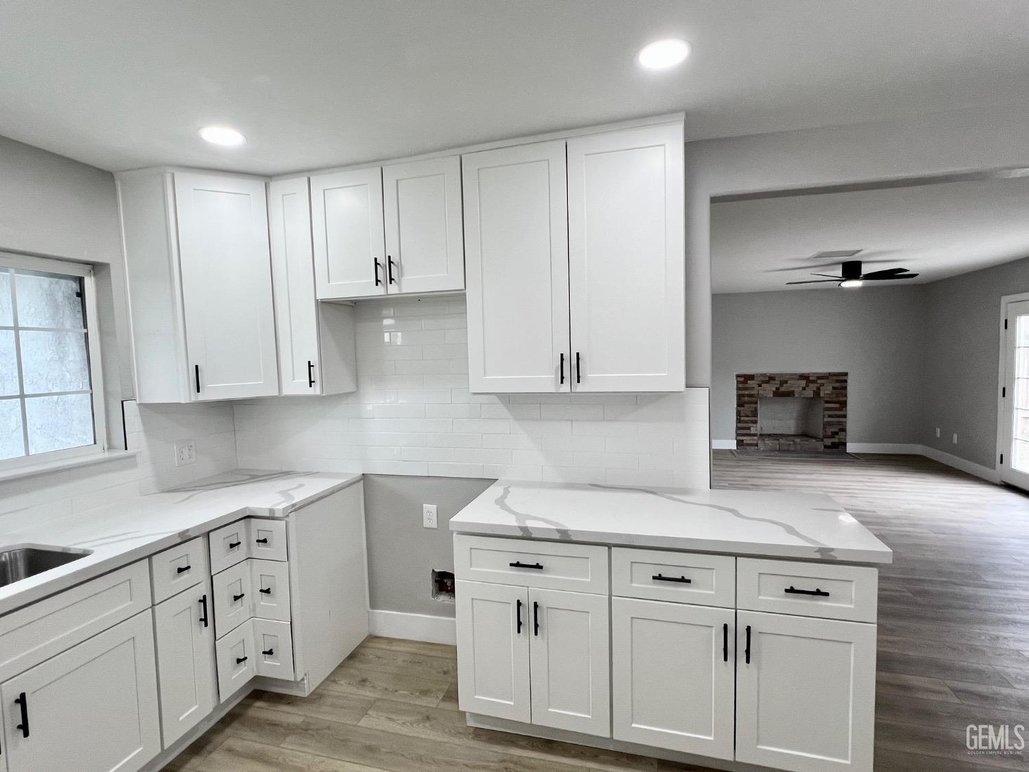 Undisclosed Address Bakersfield, CA 93307 - Photo 8 of 24 a kitchen with white cabinets and white appliances