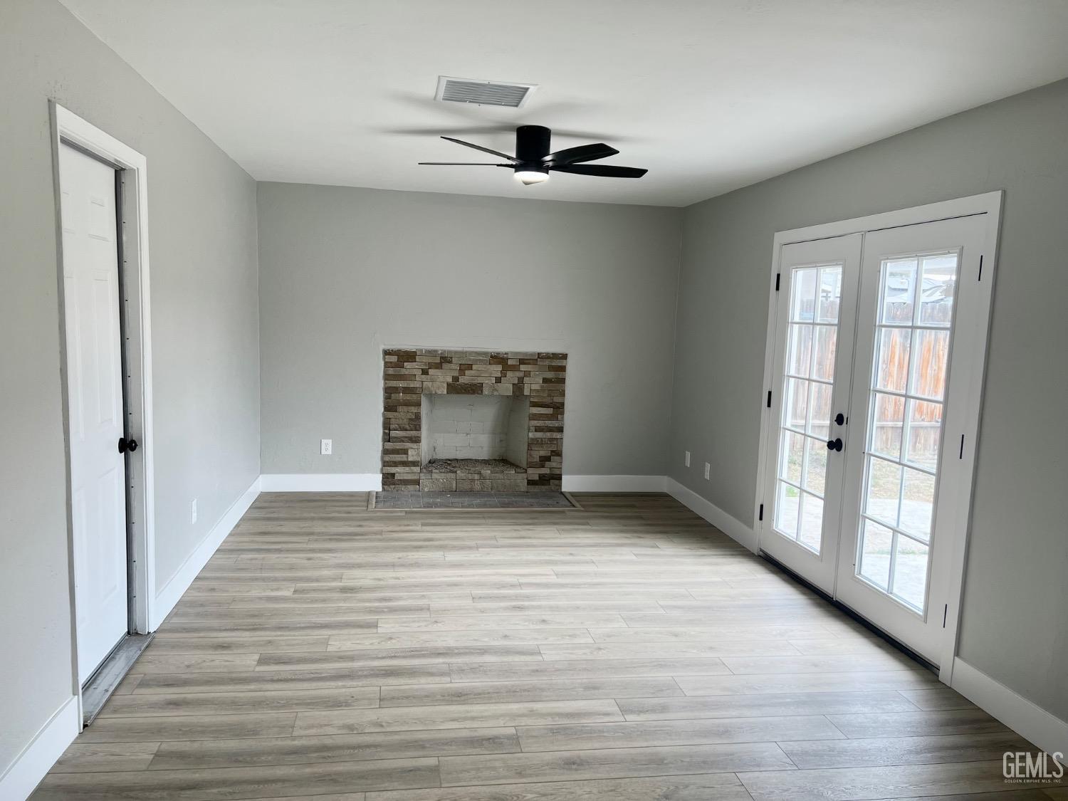 Undisclosed Address Bakersfield, CA 93307 - Photo 10 of 24 wooden floor in an empty room with a window
