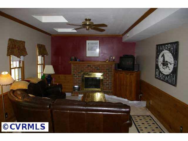 13814 Laurel Spring Road Chester, VA 23831 - Photo 3 of 8 a living room with furniture and a fireplace