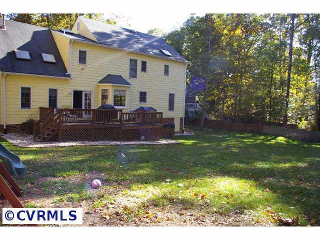 13814 Laurel Spring Road Chester, VA 23831 - Photo 5 of 8 a front view of house with yard and outdoor seating