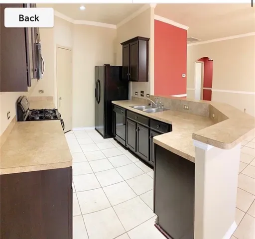 a kitchen with stainless steel appliances a sink stove and refrigerator