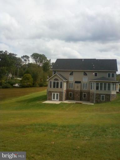 19930 Gunpowder Road Manchester, MD 21102 - Photo 2 of 30 a view of a house with a big yard and large trees