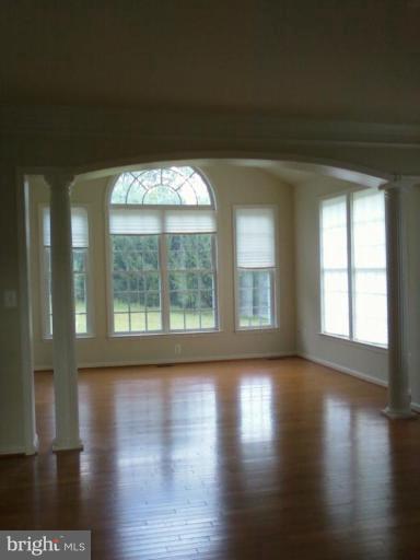 19930 Gunpowder Road Manchester, MD 21102 - Photo 16 of 30 a view of an empty room with wooden floor and a window