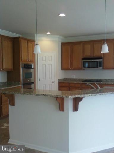 19930 Gunpowder Road Manchester, MD 21102 - Photo 9 of 30 a kitchen with stainless steel appliances granite countertop a stove a sink and a refrigerator