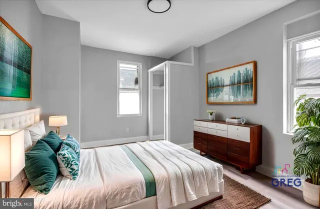 a bedroom with a bed and a potted plant