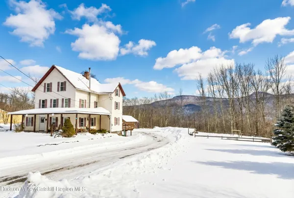 a view of a white house with a yard