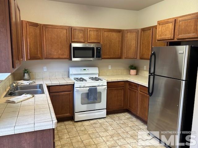 4628 Kathleen Denise Lane Reno, NV 89503 - Photo 6 of 13 a kitchen with a refrigerator sink and microwave