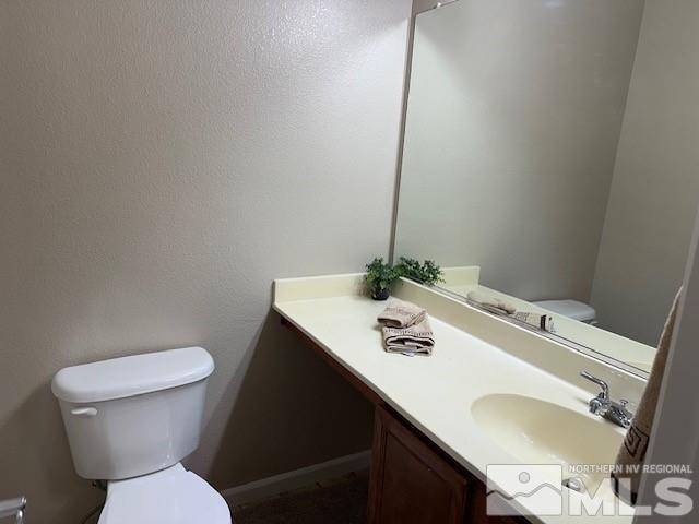 4628 Kathleen Denise Lane Reno, NV 89503 - Photo 8 of 13 a white toilet sitting next to a bathroom sink