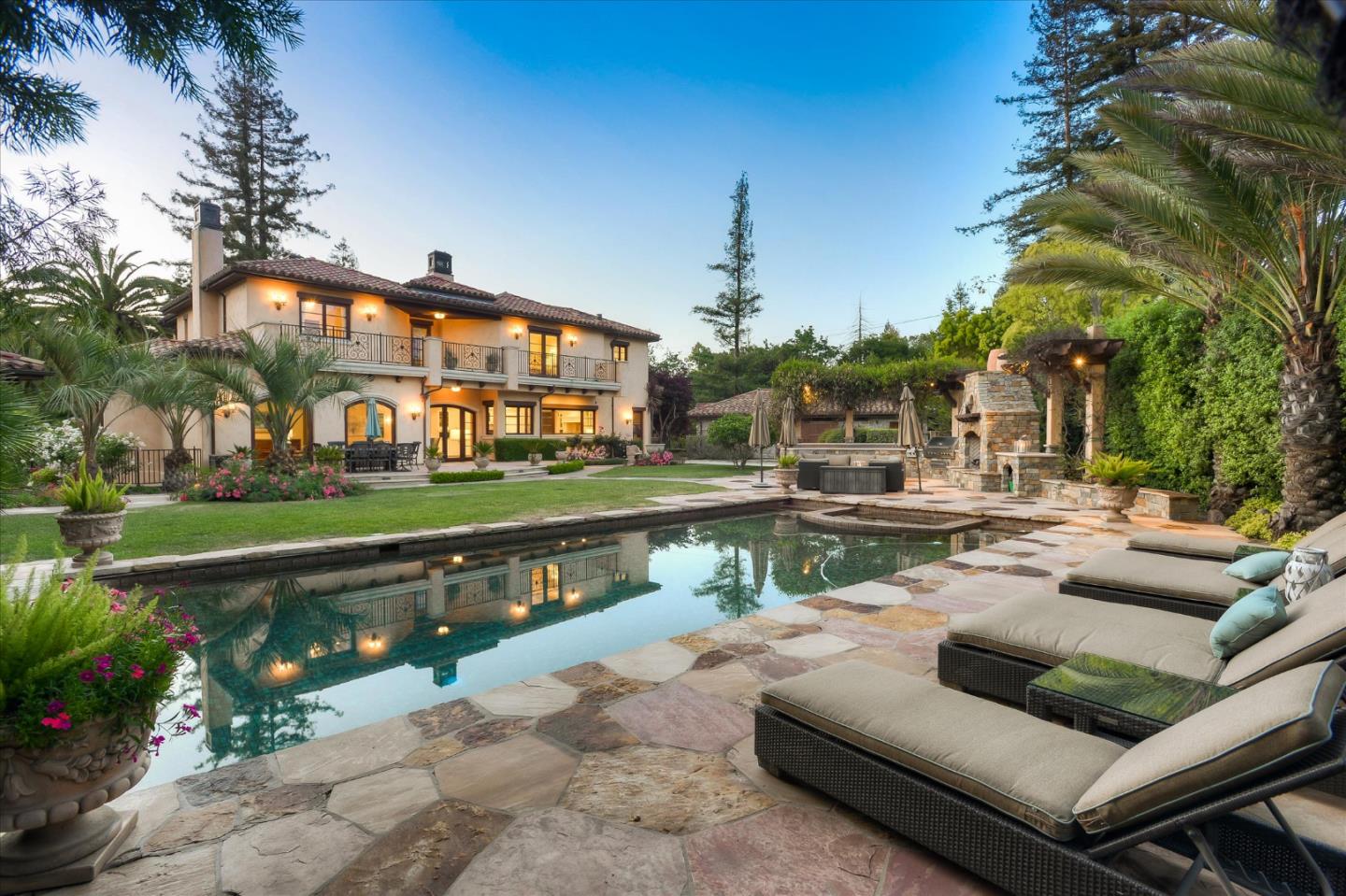 a view of house with swimming pool and outdoor seating