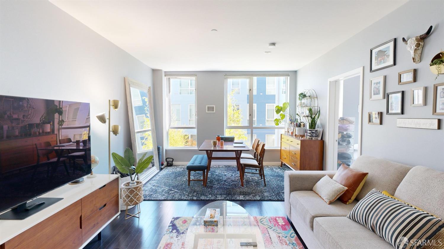 888 7th Street, Unit 234 San Francisco, CA 94107 - Photo 1 of 10 a living room with furniture fireplace and a flat screen tv