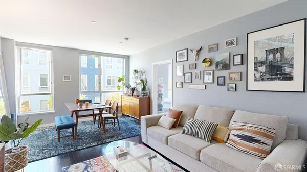 a living room with furniture and painting on the wall