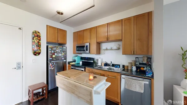 a kitchen with stainless steel appliances granite countertop a refrigerator sink and cabinets