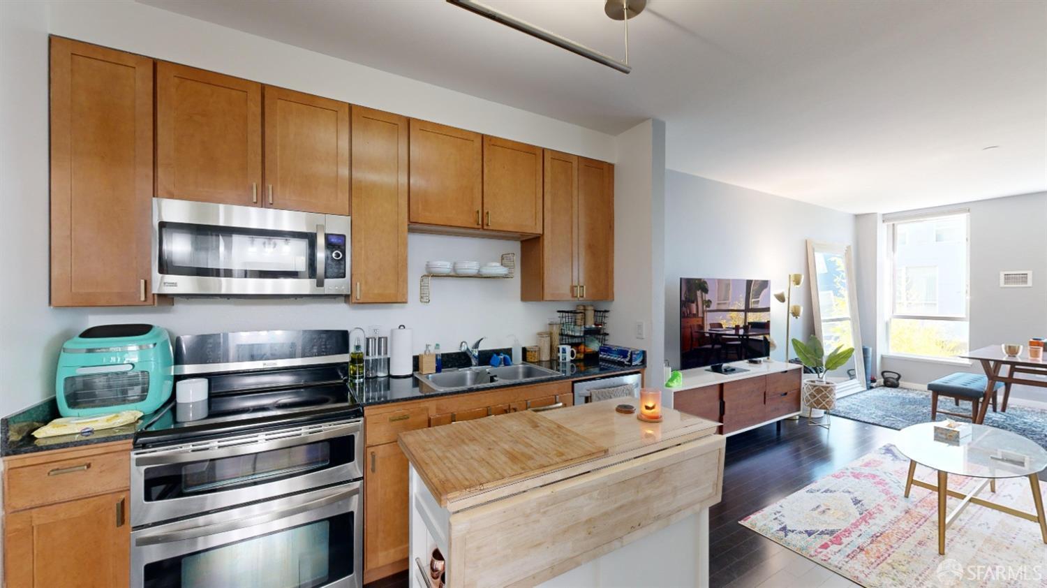888 7th Street, Unit 234 San Francisco, CA 94107 - Photo 6 of 10 a kitchen with stainless steel appliances a stove a sink a microwave and cabinets