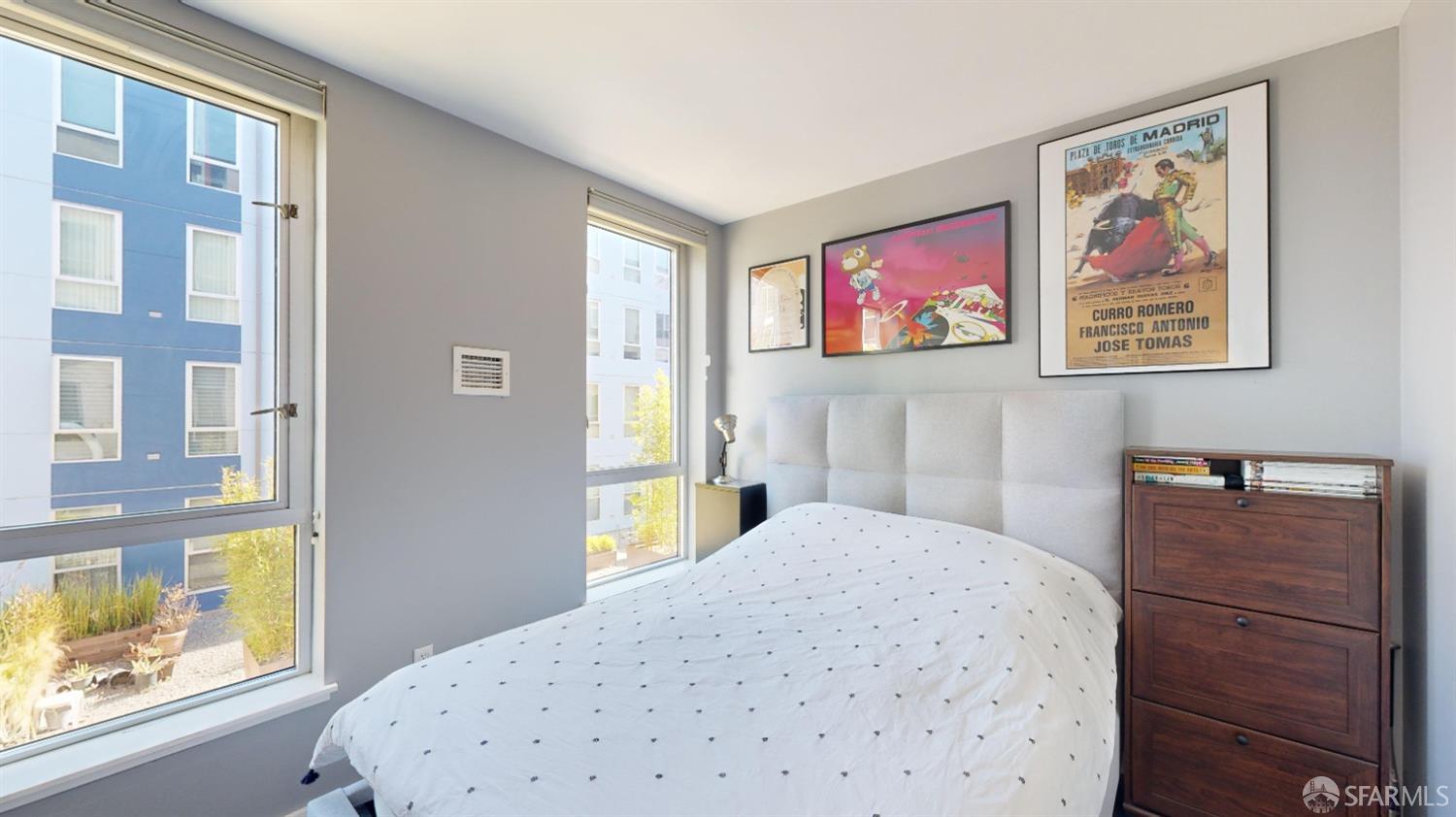 888 7th Street, Unit 234 San Francisco, CA 94107 - Photo 7 of 10 a bedroom with a bed and a window
