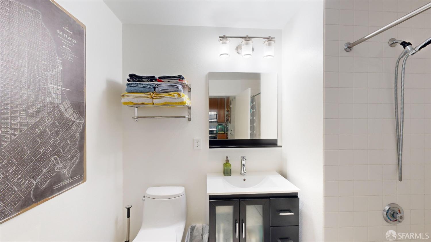 888 7th Street, Unit 234 San Francisco, CA 94107 - Photo 10 of 10 a bathroom with a toilet sink and mirror